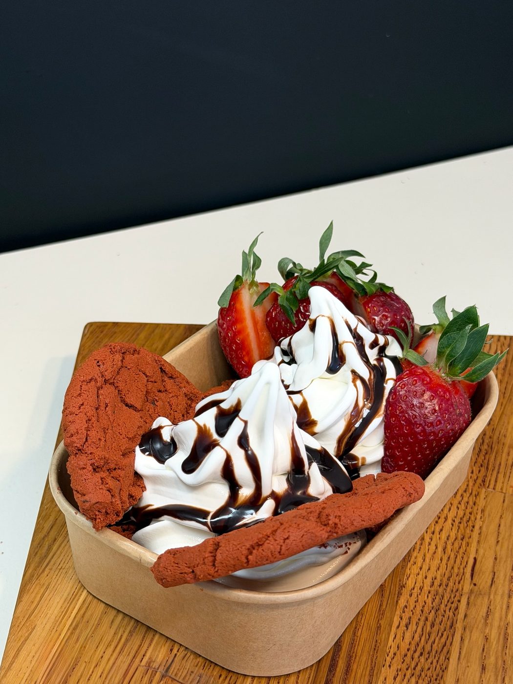 Revala soft serve with chocolate drizzle and strawberries